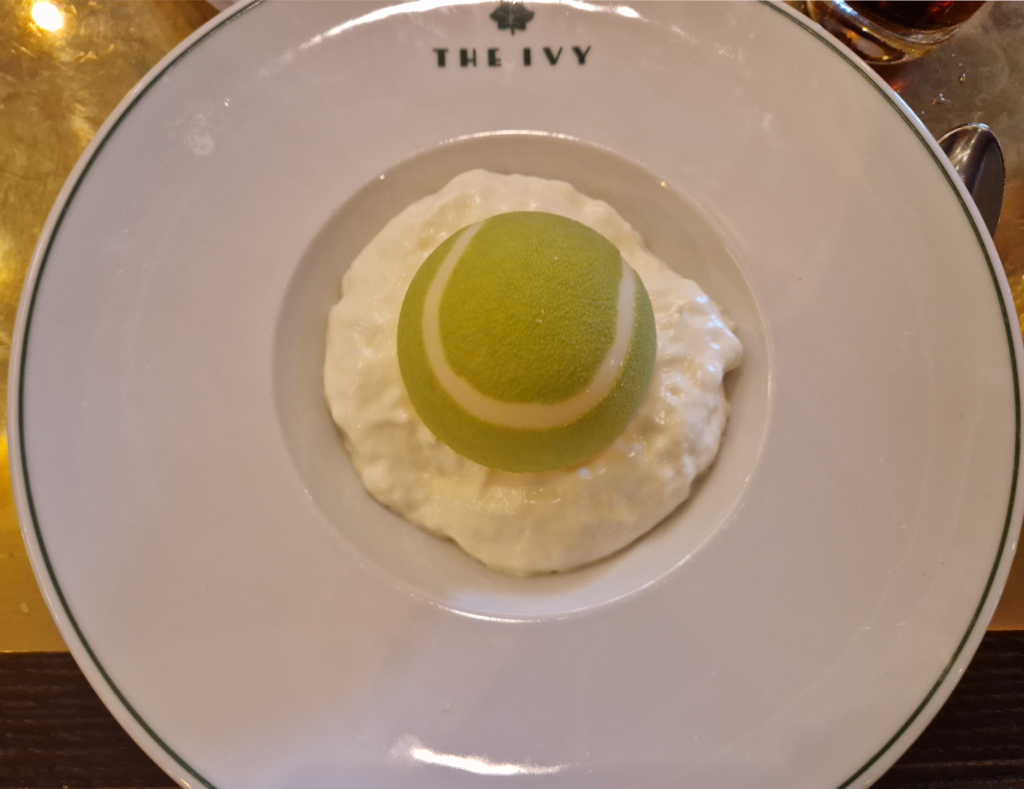 Picture of The Wimbledon Bombe at The Ivy - White Chocolate dome shaped like a tennis ball.